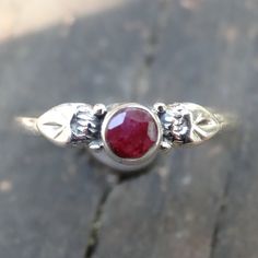 Handmade, Natural Raw (untreated) Ruby Sterling Silver Botanical Dainty Ring Featured in this listing are Sterling Silver, handmade, natural stone rings. These lovely ring feature a beautiful, Natural untreated Ruby round 5mm(approx.) stones. All hand set into .925 Sterling Silver. Please note that there will be natural inclusions, as this ring is untreated, and in it's purest form. There are slight color difference due to nature of each unique stone. Detailed leaf design along each side of the Silver Ruby Ring, Botanical Ring, Be Natural, Lovely Ring, Natural Ruby, Silver Accents, Ruby Ring, Rocks And Gems, Dainty Ring