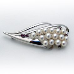 "Vintage sterling silver brooch, decorated with Akoya Pearl cluster and accented with Rubies. This elegant brooch is 2 3/4\" long, 1 1/8\" wide and weighs 14.7 grams; Pearls are 6.5-7 mm in diameter. EA1876" Sterling Silver Brooch, Pearl Cluster, Akoya Pearls, Silver Brooch, Tennis Bracelet, Vintage Sterling Silver, Beautiful Bracelet, Ruby, Unique Pieces