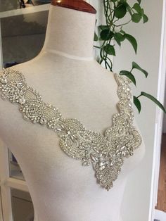 Gorgeous luxury rhinestone applique , clear crystal and pearl beaded wedding gown lace appliques, all the stones are hand sewn by silver thread which are base ground tulle ,making it more elegant and adorble . widest points: 32cm / 12.6 inches highest points: 29cm / 11.4 inches Back to shop directory https://www.etsy.com/shop/Retrolace?ref=si_shop Silver Lace Bridal Accessories For Wedding, Elegant Silver Embellished Wedding Dress, Silver Embellished Wedding Dress, Embellished Silver Wedding Dress, Wedding Gown Beaded, Pearl Applique, Beaded Wedding Gowns, Bridal Applique, Iron On Fabric