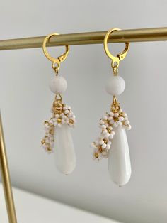 Introducing my exquisite Beaded White Jade teardrop earrings, perfect for adding a touch of elegance to any occasion. Round White Jade bead and mini beaded flowers is delicately placed to create a mesmerizing design and looks super cute. The 10x30mm natural White stone teardrop adds an extra dimension to these earrings, making them a unique and glamorous accessory. With a total lenght of 7 cm including the latch back closure, these earrings are the perfect size to make a statement without being Elegant Gemstone Beads Dangle Earrings, Elegant Dangle Earrings With Gemstone Beads, Elegant Teardrop Crystal Earrings With Dangling Beads, Elegant Gemstone Beaded Earrings For Gift, Gemstone Beads Dangle Earrings For Jewelry Making, Gemstone Beaded Dangle Earrings For Jewelry Making, Dangle Beaded Earrings With Gemstone Beads For Jewelry Making, Elegant Gemstone Beads Drop Earrings, Elegant Flower Earrings With Dangling Beads