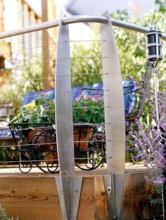 an outdoor planter with flowers and plants in it