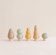 small wooden toys are lined up in a row