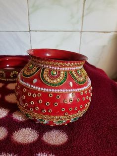 a red vase sitting on top of a table