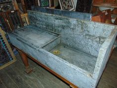 an old metal sink sitting on top of a wooden floor