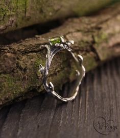 This silver engagement ring has a character all its own. A thin twig with leaves grows freely as it wants. And the peridot, as green as spring grass, is caught in the clutches of the twigs. This unique ring is the perfect gift for a wild forest fairy. Green Proposal Ring, Bug Engagement Rings, Forest Engagement Rings, Silver Unique Wedding Rings, Earthy Wedding Rings Silver, Green Silver Ring, Woodland Engagement Ring, Green Stone Wedding Ring, Fantasy Engagement Rings Silver