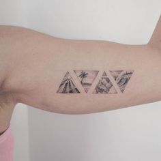 a man's arm with three triangles and palm trees on the left side of his arm