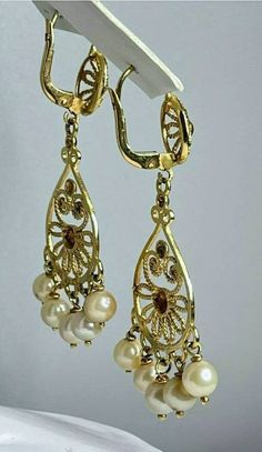 "Gorgeous vintage chandelier earrings! Pair of Marked 750 (18K) yellow gold saltwater cultured pearl chandelier style pierced earrings. Attached to the earrings are well made leverback style earring fasteners, designed to match the chandelier earring. Each saltwater cultured pearl measures approximately 4.80 mm x 4.80 mm. Each earring measures approximately 1 3/4\" long x 3/4\" wide. The pair of 18K yellow gold pearl earrings weigh 8.90 grams. The beautiful chandelier style earrings come in a qu Formal Yellow Gold Chandelier Earrings With Intricate Design, Ornate Yellow Gold Dangle Chandelier Earrings, Ornate Yellow Gold Chandelier Dangle Earrings, Ornate Filigree Chandelier Earrings For Formal Occasions, Ornate Chandelier Earrings For Formal Occasions, Luxury Gold Pearl Drop Chandelier Earrings, Luxury Gold Chandelier Earrings With Pearl Drop, Yellow Gold Dangle Chandelier Earrings For Formal Occasions, Victorian Gold Chandelier Earrings For Formal Occasions