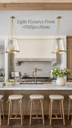 a kitchen island with four stools next to it and an oven in the background