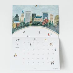 an image of a calendar with people skiing in the city on it's cover