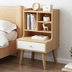 a bedroom with a bed, nightstand and bookshelf on the shelf next to it