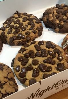 a box filled with chocolate chip cookies on top of a table