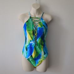 La Blanc Green & Blue Tropical Strappy Crisscross One-Piece Swimsuit Size 10. New With Tags. Convertible Straps. Stomach Control Panel. Hygiene Sticker In Place. Women's Size 10.. Measurements Are Approximate. Sleeve Length: N/A Pit To Pit: 16" Shoulder To Hem: 31" Max. Adjustable Shoulder Straps. Please See Photos For Any Minor Imperfections Or Signs Of Wear. Shipping Weight: 6.2oz Dog-Loving, Smoke Free Home. Typically Ships Within 24hours M-F. Recyclable, Minimalist Packaging. Blue Cross Back Swimwear For Beach Season, Summer Crisscross Swimwear With Lined Body, Summer Bodysuit With Crisscross Straps For Poolside, Blue Cross Back Swimwear For Beach, Blue Cross Back Swimwear For Vacation, Summer Swimwear With Cross-tied Back, Summer Crisscross Swimwear For Pool, Summer Vacation Strappy Bodysuit, Crisscross Swimwear For Summer Pool