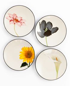 four plates with flowers painted on them