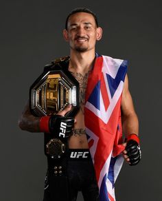 a man holding a flag and a wrestling belt