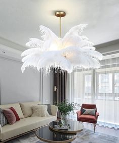 a living room filled with furniture and a large white chandelier hanging from the ceiling