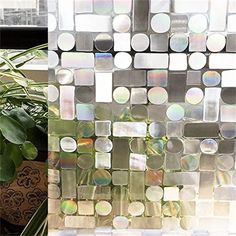 there is a glass mosaic on the window sill next to a potted plant