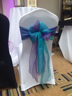 a chair with a blue and purple sash on it