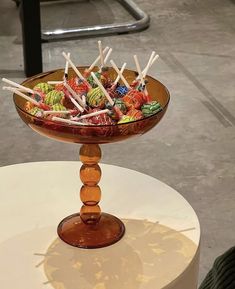 a bowl filled with lots of candy on top of a table