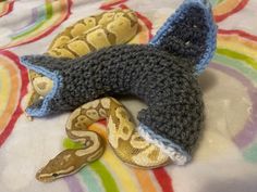 two stuffed snakes are laying on a bed