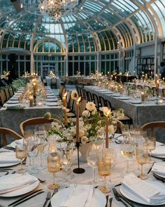 a dining room with tables and chairs set up for an event or function in front of a glass ceiling