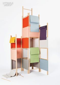 a multicolored wooden shelf with folded towels and other items on it's sides