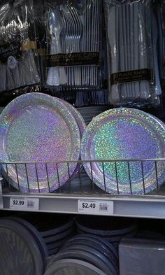 plates are on display in a store with holographics and plastic wrap around them