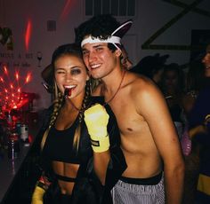 two people standing next to each other at a party