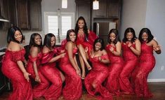 a group of women in red dresses posing for the camera