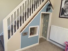 a dog house built into the side of a stair case in a child's room