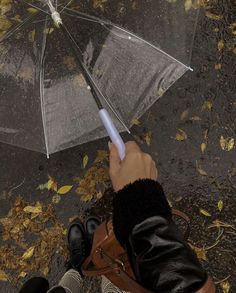 a person holding an umbrella in the rain