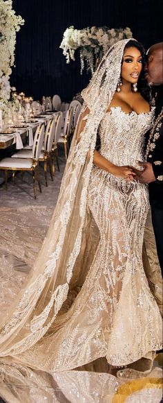 the newly married couple is posing for a photo in their wedding gowns and veil