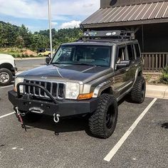 a jeep parked in a parking lot next to a building