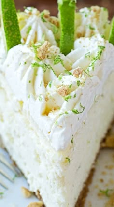 a piece of cake with white frosting and green garnish on the top