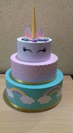 three tiered cake with an unicorn face on top