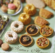 a table topped with lots of different types of pastries on top of each other