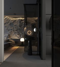 an open door leading to a bedroom with a stone wall behind it and lights on the floor