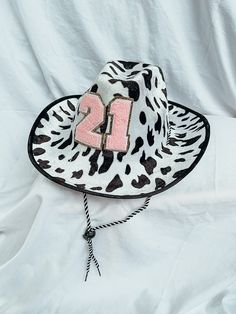 a cow print hat with the number one on it