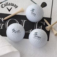 three golf balls and tees on a towel