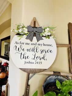 a wooden sign that says as for me and my house we will serve the lord