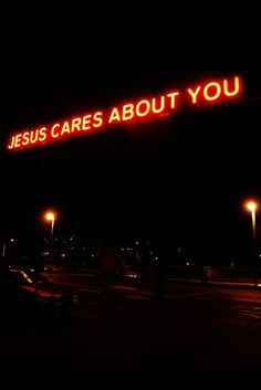 a neon sign that says jesus cares about you