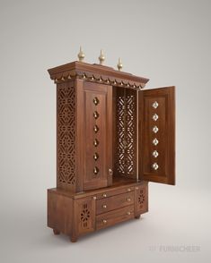 an intricately carved wooden cabinet with brass knobs