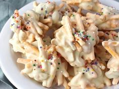 a white plate topped with cookies and sprinkles on top of a table