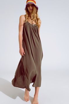 Elevate your summer wardrobe with this effortlessly chic khaki maxi dress. Crafted from 100% viscose, it offers a flowy fit and lightweight comfort, perfect for warm weather. The dress features delicate spaghetti straps adorned with intricate beaded details, adding a touch of elegance to the ensemble. With its round neckline and relaxed silhouette, this versatile dress can be worn as a stylish cover-up or as a standalone piece for any occasion.   Material: 100% Viscose  Model is wearing size S.  Model is: 29-25-35 Height: 5'11''.  The S-M sizing corresponds to US sizes of 4 and 6 respectively.  Relaxed Fit.  Length: Standard.  Maxi length  Sleeveless style  Relaxed fit  Comfy  Criss-cross design at back  Lightweight woven fabric Casual Khaki Midi Dress For Summer, Green Floor-length Slip Dress For Summer, Casual Spring Khaki Maxi Dress, Solid Color Maxi Slip Dress For Summer, Floor-length Viscose Beach Dress, Casual Floor-length Rayon Dresses, Casual Khaki Maxi Dress, Green Viscose Maxi Dress For Summer, Casual Khaki Maxi Dress For Vacation