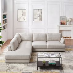 a living room with a sectional couch and coffee table on the floor in front of it