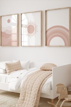 a bedroom with three pictures hanging on the wall