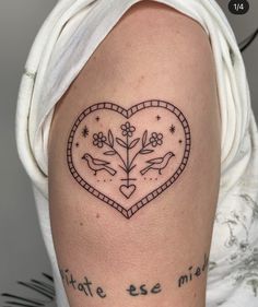 a woman with a heart tattoo on her arm