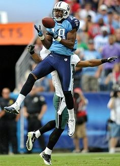 two football players are jumping in the air