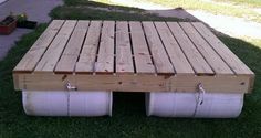 a wooden pallet sitting on top of green grass