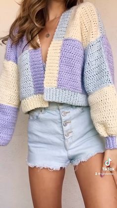 a close up of a person wearing shorts and a sweater