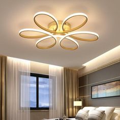 the modern ceiling light is suspended above a bed